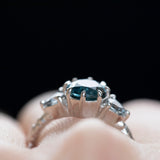 1.80ct Blue Montana Sapphire and Grey Spinel Three Stone Low Profile Evergreen Ring in Platinum on hand