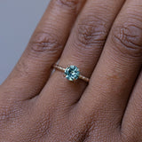 1.01ct Round Blue Montana Sapphire Evergreen Solitaire Ring in 14k Yellow Gold on the hand