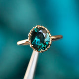 3.17ct Teal Oval Madagascar Sapphire Scallop Cup Sapphire Solitaire in 14K Yellow Gold in tweezers
