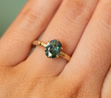 1.68ct Oval Teal Sapphire Lotus Six Prong Solitaire Ring in 14k Yellow Gold on hand