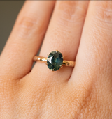1.68ct Oval Teal Sapphire Lotus Six Prong Solitaire Ring in 14k Yellow Gold on hand