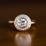 0.89 Old European Cut Diamond in Rose Gold Bezel Set Halo Evergreen on table