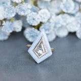 2.39 Kite Rosecut Diamond and Blue Agate Gemstone Halo Ring in Two Tone Gold on table in front of white and light blue flowers