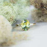 4.21ct Oval Parti Sapphire and Tapered Baguette Diamond Ring in 18k Yellow Gold on table