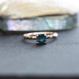 0.90ct Australian Square Cut Sapphire Evergreen Solitaire in 14k Rose Gold on table