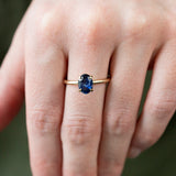 1.53ct Oval Royal Blue Sapphire Solitaire Ring In 14K Yellow Gold on hand