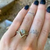 Grey Moissante and Scattered Diamond Solitaire in 14k Yellow Gold on hand with v diamond band