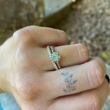 Grey Moissante and Scattered Diamond Solitaire in 14k Yellow Gold with straight diamond band on hand