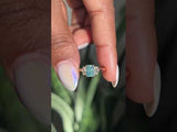 1.47ct Radiant Opalescent Teal Sapphire and White Sapphire Three Stone Ring in 14k Yellow Gold