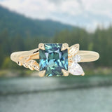1.65ct Teal Blue Radiant Cut Madagascar Sapphire in Wandering Vine Low Profile 4 Prong Setting with Diamonds in 14k Yellow