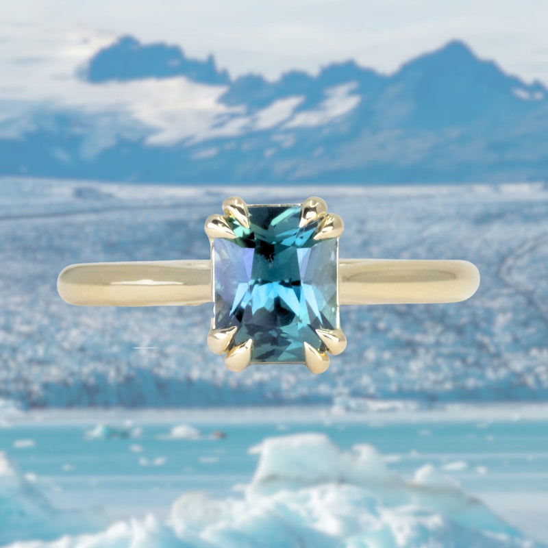 1.68ct Radiant Cut Teal Sapphire Cathedral Double Prong Solitaire in 18k Yellow Gold