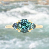 1.82ct Round Teal Precision Cut Montana Sapphire and Trillion Sapphire Low Profile Three Stone Ring in 18k Yellow Gold