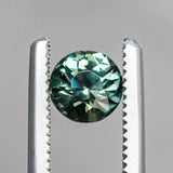 1.13CT BRILLIANT ROUND MADAGASCAR SAPPHIRE, COLOR SHIFTING WARM GREY TO BRIGHT GREEN TEAL, 5.72X74.42MM