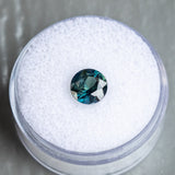 1.59CT ROUND NIGERIAN SAPPHIRE, DEEP TEAL WITH PARTI GREEN, 7.00X4.34MM, UNTREATED