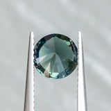 1.59CT ROUND NIGERIAN SAPPHIRE, DEEP TEAL WITH PARTI GREEN, 7.00X4.34MM, UNTREATED