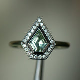 0.70ct Shield Cut Montana Sapphire and Blackened Gold Bezel Set Diamond Halo In 14k Green Gold