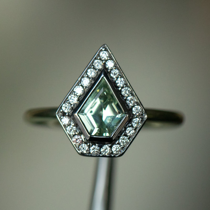 0.70ct Shield Cut Montana Sapphire and Blackened Gold Bezel Set Diamond Halo In 14k Green Gold