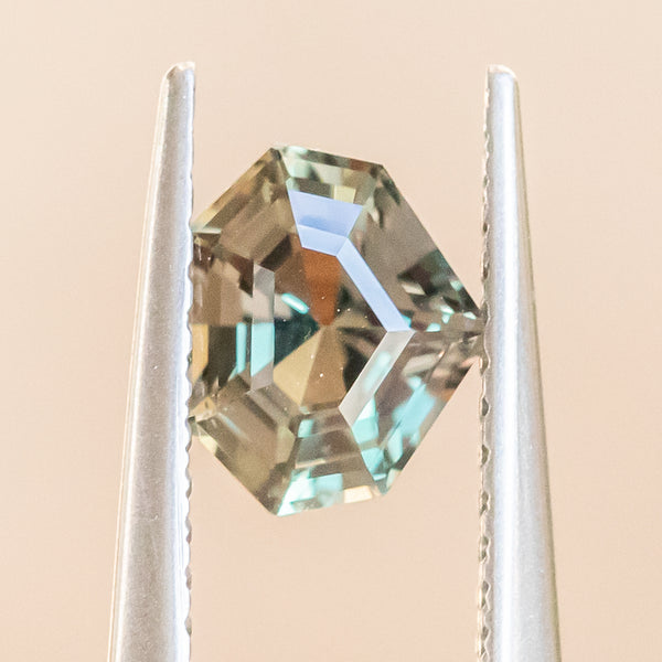 1.03CT SHIELD TANZANIAN SAPPHIRE, COLOR SHIFTING GREEN AND COGNAC, 6.6X5.5X3.7MM, UNTREATED