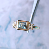 1.06ct Unheated Step Cut Teal Bezel Set Sapphire and White Cadillac Prong Set Sapphire Low Profile Three Stone Ring in 14k Yellow Gold