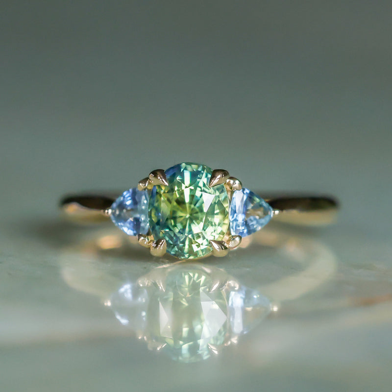 1.61ct Oval Madagascar Parti Sapphire and Trillion Sapphire Three Stone Low Profile Ring in 14k Yellow Gold