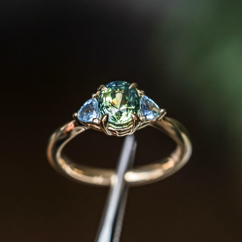 1.61ct Oval Madagascar Parti Sapphire and Trillion Sapphire Three Stone Low Profile Ring in 14k Yellow Gold