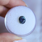 1.73CT PRECISION CUT OVAL MONTANA SAPPHIRE, DENIM PARTI TEAL WITH EARTHY INCLUSIONS, 7.47X6.16X4.69MM