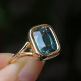 4.09ct Elongated Cushion Cut Teal Sapphire Low Profile Split Shank Bezel Ring in 14k Yellow Gold- Appraised Stone