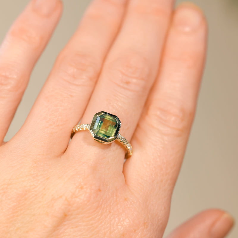 2.18ct Emerald Cut Parti Madagascar Sapphire Low Profile Bezel Solitaire Ring with Pavé Set Diamonds in 14k Green Gold
