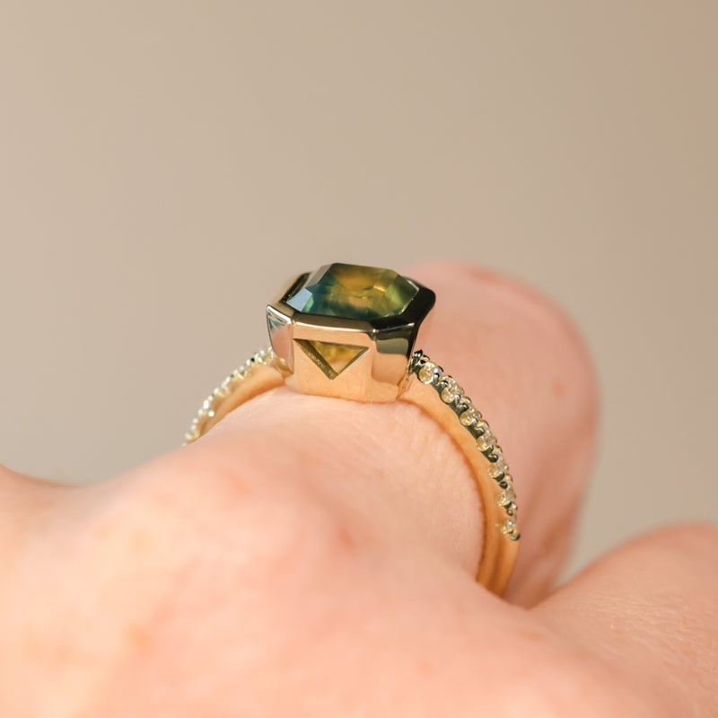 2.18ct Emerald Cut Parti Madagascar Sapphire Low Profile Bezel Solitaire Ring with Pavé Set Diamonds in 14k Green Gold