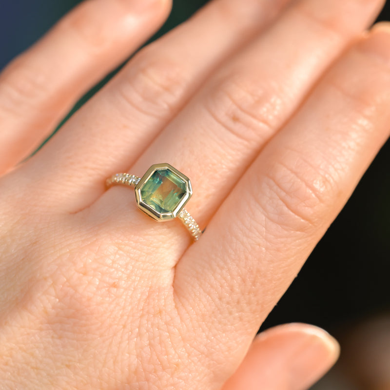 2.18ct Emerald Cut Parti Madagascar Sapphire Low Profile Bezel Solitaire Ring with Pavé Set Diamonds in 14k Green Gold