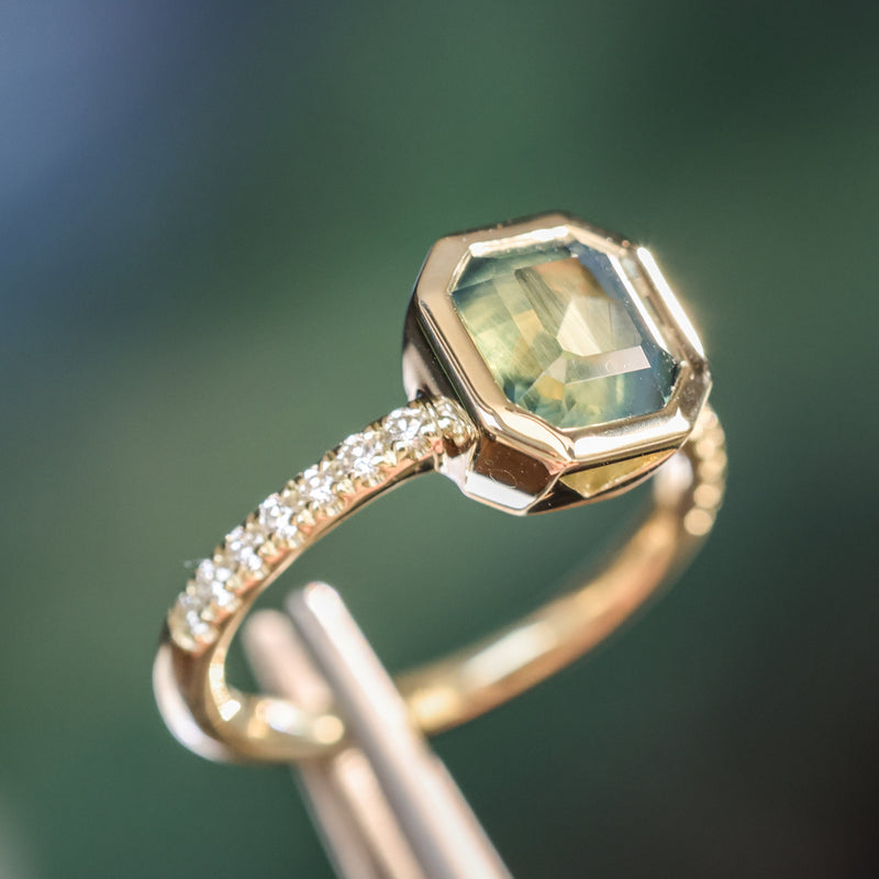 2.18ct Emerald Cut Parti Madagascar Sapphire Low Profile Bezel Solitaire Ring with Pavé Set Diamonds in 14k Green Gold
