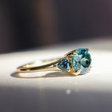 1.82ct Round Teal Precision Cut Montana Sapphire and Trillion Sapphire Low Profile Three Stone Ring in 18k Yellow Gold