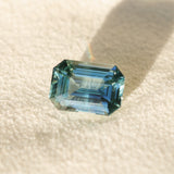 6.91CT UNTREATED EMERALD CUT MADAGASCAR SAPPHIRE, AQUA BLUE GREEN-GREY, 12.1X8.6X6.3MM