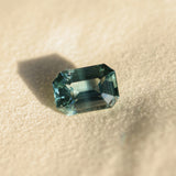 6.91CT UNTREATED EMERALD CUT MADAGASCAR SAPPHIRE, AQUA BLUE GREEN-GREY, 12.1X8.6X6.3MM