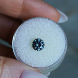 1.39CT ROUND PRECISION CUT MONTANA SAPPHIRE, COLOR SHIFTING TEAL TO PURPLE GREY, 6.5X4.3MM