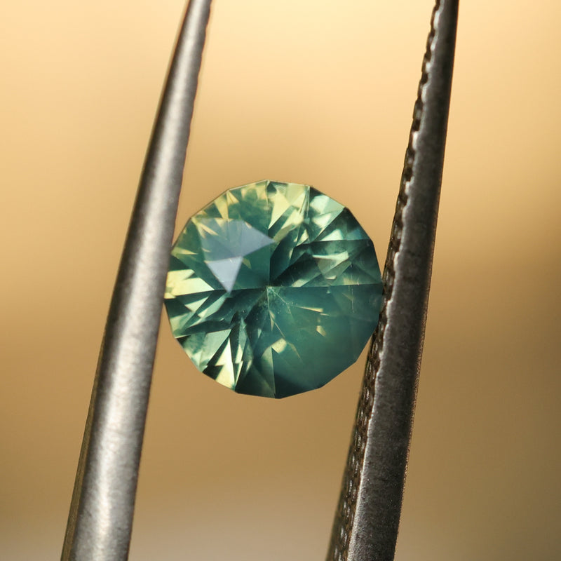 1.29CT ROUND MADAGASCAR SAPPHIRE, SILKY YELLOW GREEN PARTI, UNTREATED, 6.4X4.22MM