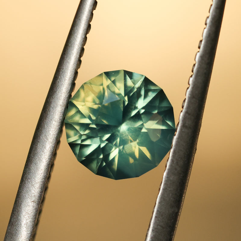 1.29CT ROUND MADAGASCAR SAPPHIRE, SILKY YELLOW GREEN PARTI, UNTREATED, 6.4X4.22MM