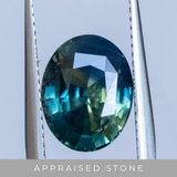 4.58CT OVAL MADAGASCAR SAPPHIRE, PARTI BLUE GREEN YELLOW, 11.28X8.82X5.56MM - APPRAISED STONE