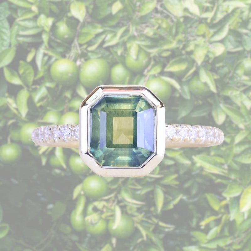 2.18ct Emerald Cut Parti Madagascar Sapphire Low Profile Bezel Solitaire Ring with Pavé Set Diamonds in 14k Green Gold