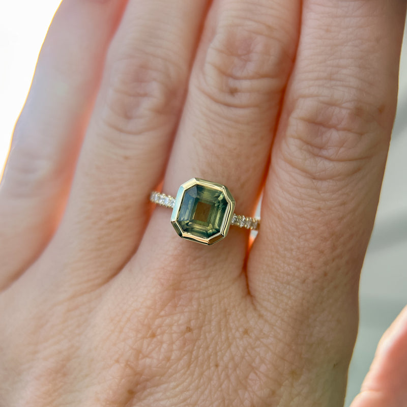2.18ct Emerald Cut Parti Madagascar Sapphire Low Profile Bezel Solitaire Ring with Pavé Set Diamonds in 14k Green Gold