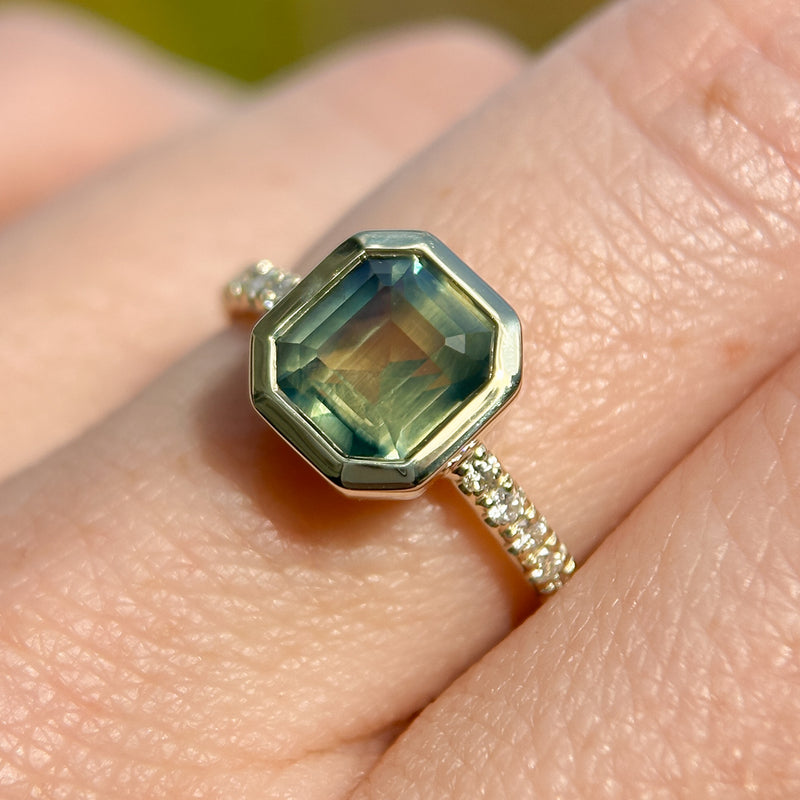 2.18ct Emerald Cut Parti Madagascar Sapphire Low Profile Bezel Solitaire Ring with Pavé Set Diamonds in 14k Green Gold