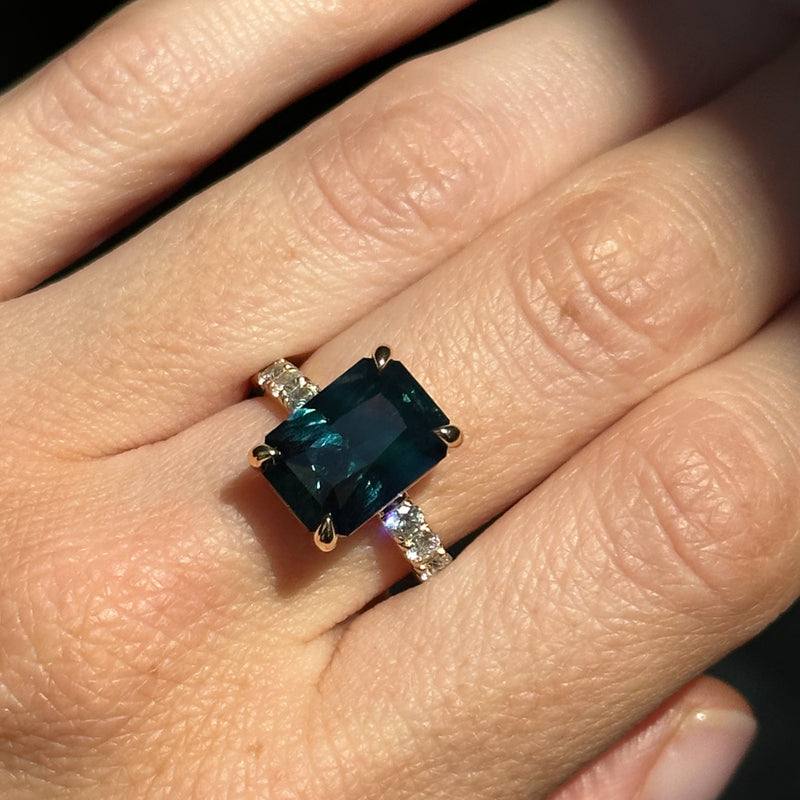 6.12ct Deep Teal Blue Madagascar Radiant Cut Sapphire Solitaire Ring with French Set Diamonds in 18k Yellow Gold