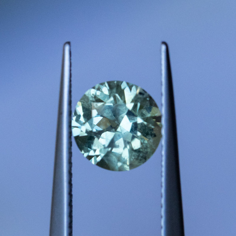 1.79CT ROUND PRECISION CUT MONTANA SAPPHIRE, LIGHT GREEN WITH PARTI BLUE, 7.3x4.71MM