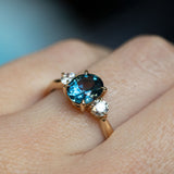 1.54ct Oval Montana Sapphire and Diamond Three Stone Ring in 14k Yellow Gold on hand