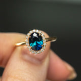 1.55ct Oval Blue Nigerian Sapphire and Diamond Four Prong Halo Ring in 14k Yellow Gold on fingers