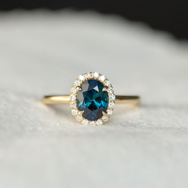 1.55ct Oval Blue Nigerian Sapphire and Diamond Four Prong Halo Ring in 14k Yellow Gold
