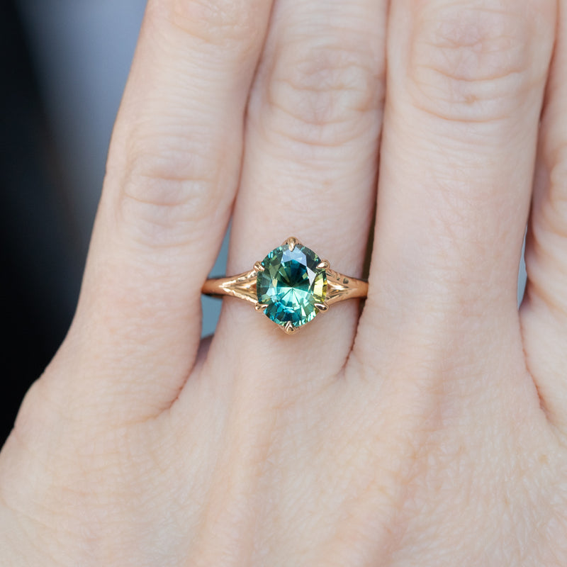 2.40ct Oval Teal Green Parti Sapphire Evergreen Carved Split Shank Six Prong Ring in 14k Yellow Gold on hand