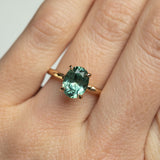 2.23ct Oval Seafoam Montana Sapphire Evergreen Solitaire in 14k Yellow Gold on hand
