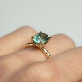 2.23ct Oval Seafoam Montana Sapphire Evergreen Solitaire in 14k Yellow Gold on hand