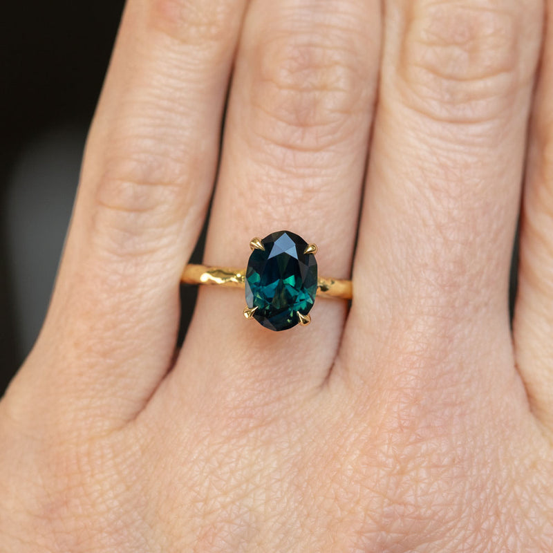 2.30ct Oval Australian Deep Teal Sapphire Evergreen Solitaire in 18k Yellow Gold on hand